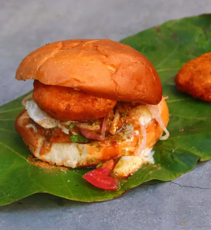 A bun tikki with chutney and onion